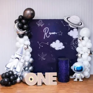 Space theme first birthday balloon decoration with astronaut backdrop and balloon arch in Mumbai